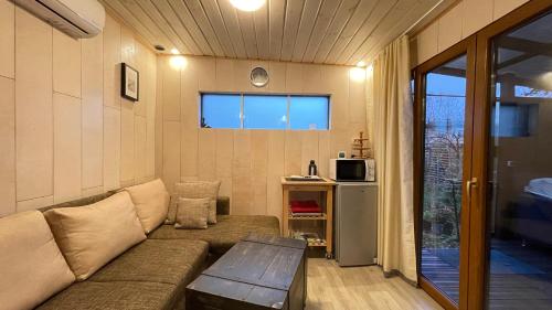 a living room with a couch and a table at Lauku iela 25 in Jūrmala