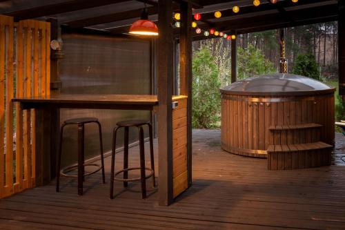 a bar on a deck with a grill and stools at Lauku iela 25 in Jūrmala