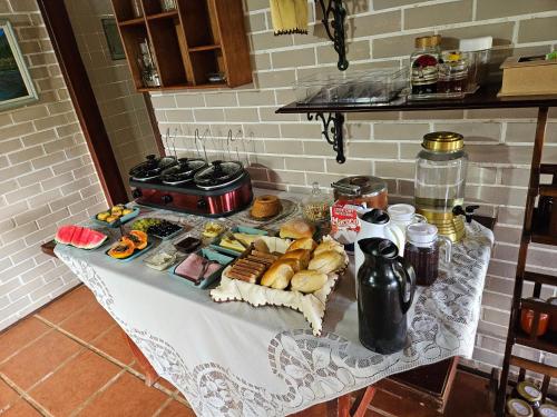 a table with a bunch of food on it at Sitio Santa Clara in Teresópolis