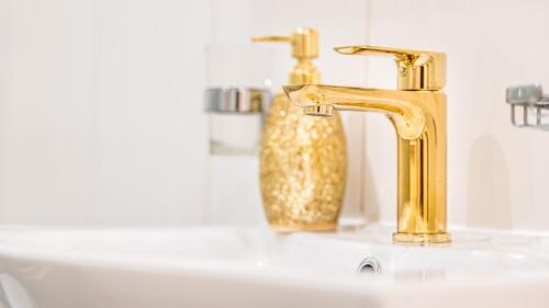 a bathroom sink with a gold faucet at Apartment Lilly in Split