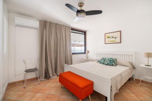 a bedroom with a bed and a ceiling fan at Sapore di Sale by DomuSicily in Palermo