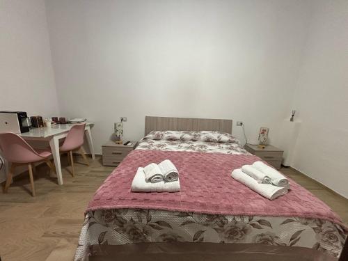 a bedroom with a bed with towels on it at CG HOME City Centre in Cosenza