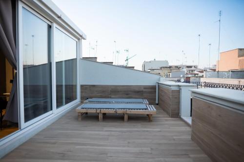 a bench sitting on top of a balcony at casa con veranda e idromassaggio in Barletta