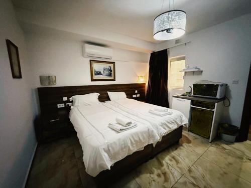 a bedroom with a bed with two towels on it at Slimiza Suites in Sliema