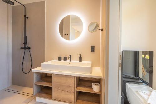 a bathroom with a sink and a mirror at Luxus Meerblick Strand & Sauna & Garten & Heimkino in Glowe