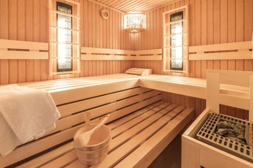 a sauna with wooden paneled walls and floors and windows at Luxus Meerblick Strand & Sauna & Garten & Heimkino in Glowe