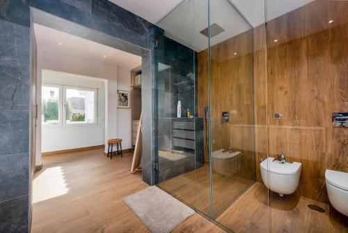 a bathroom with a glass shower and a toilet at Villa Punta Europa - Private pool with Seaview in Torreguadiaro