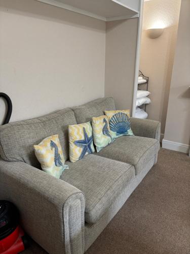 a living room with a couch with pillows on it at Carnock in Tenby