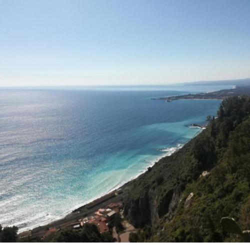 an aerial view of the ocean from a mountain at Palazzo Grecale Dell'Etna in Aci SantʼAntonio