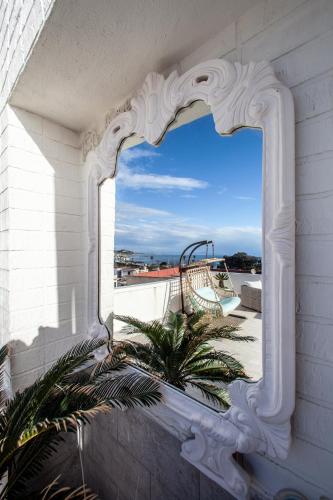 a mirror on the side of a building with a window at Naro Suites and Rooms in Bacoli