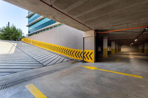 an empty parking garage with a yellow and black ramp at The Plaza Hotel Edirne in Edirne
