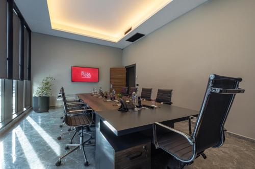 a conference room with a long table and chairs at The Plaza Hotel Edirne in Edirne