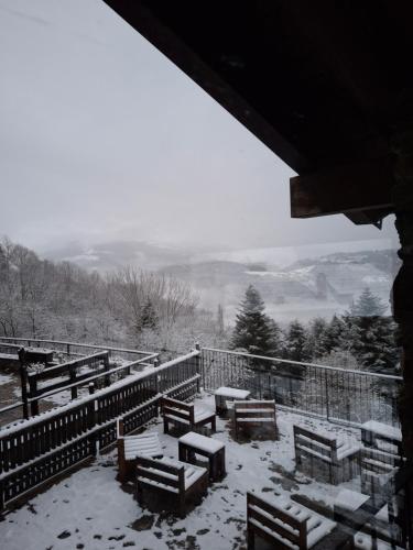 a group of tables and benches covered in snow at Cal Tonico Rural in Ribes de Freser