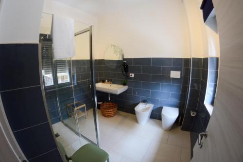 a bathroom with a shower and a toilet and a sink at Villa Vera in Salerno