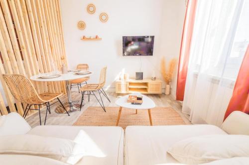 un salon avec un canapé et une table dans l'établissement Le Boheme Terracotta - Proche du centre hospitalier, à Brive-la-Gaillarde