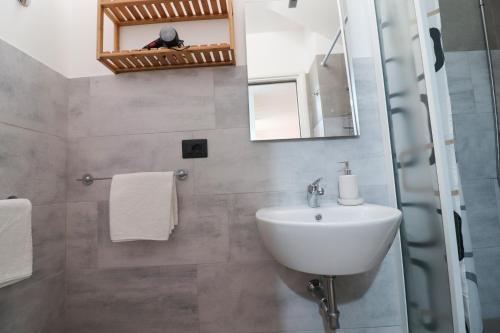 a bathroom with a sink and a mirror at Casa Malika a Otranto in Otranto