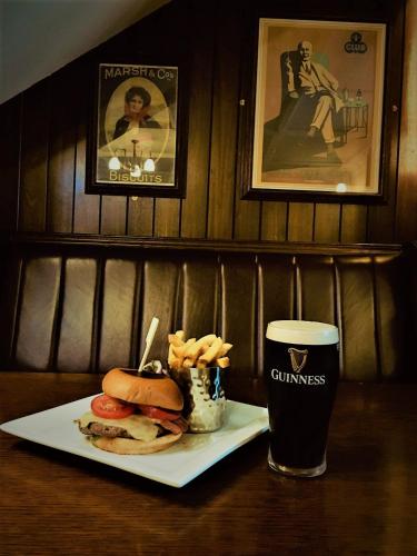 a table with a sandwich and a glass of beer at The Lansdowne Hotel in Dublin