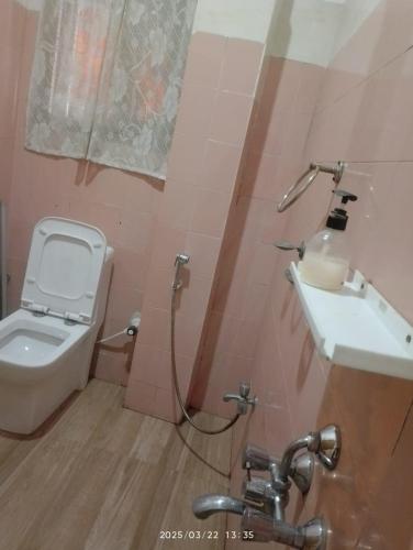 a bathroom with a toilet and a sink at Amazing Homestay in Guwahati
