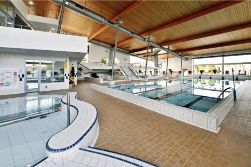a large swimming pool in a building at Riverside Apartment Praha in Prague