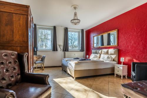 a bedroom with a bed and a red wall at Villa Backstein OBO19 in Schwerin