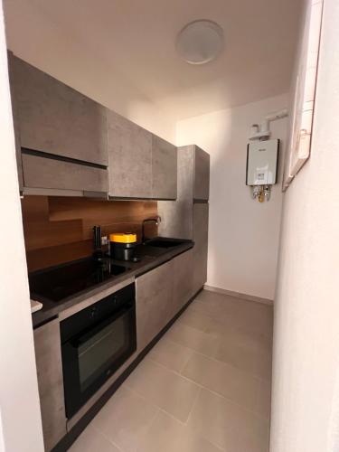 a kitchen with stainless steel cabinets and a stove at Le Mimose in Punta Ala