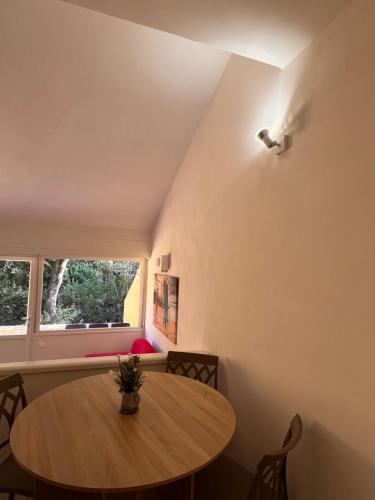 a dining room with a table and a window at Le Mimose in Punta Ala