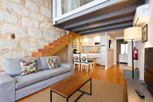 a living room with a couch and a table at RVA - Porto Central Flats in Porto