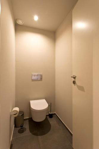 a bathroom with a white toilet in a room at RVA - Porto Central Flats in Porto