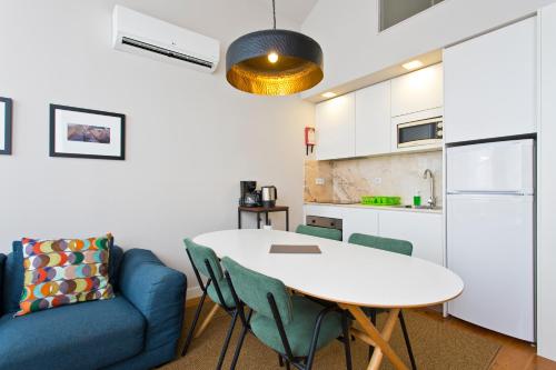 a living room with a table and a blue couch at RVA - Porto Central Flats in Porto
