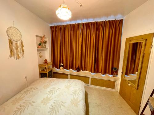 a bedroom with a bed in front of a window at Dotan's Boutique Apartments - By The Beach! in Tel Aviv