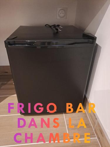 a black refrigerator with the words fico bar dances dance at Petit coin de paradis, calme et confort garantie ! Chambre indépendante dans une dépendance ! in Montauban
