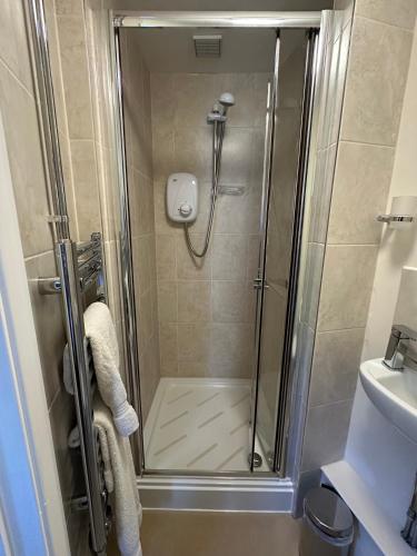 a shower with a glass door in a bathroom at Newent Golf Club and Lodges in Newent
