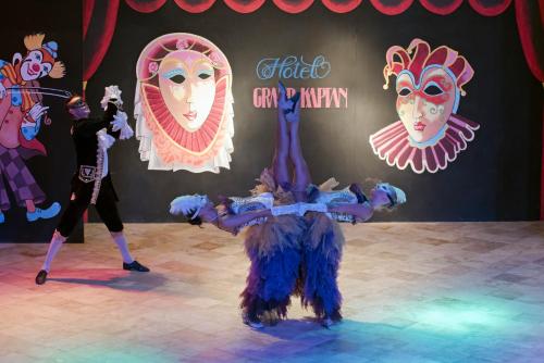 a group of people dancing on a stage with masks at Hotel Grand Kaptan - Ultra All Inclusive in Alanya