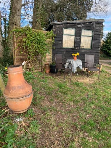 a house with a table and chairs and a vase at Stunning Location Devon in Lympstone