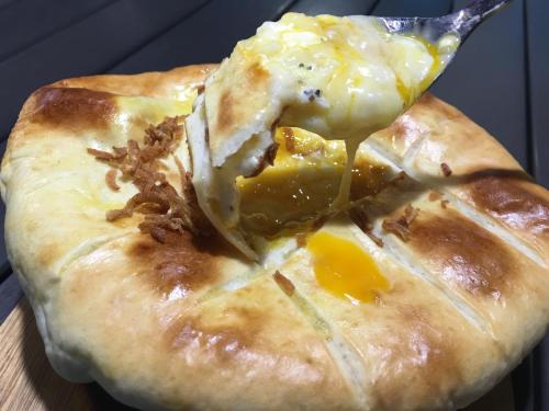 a close up of a pie with a spoon in it at Ma-Blue Garden House in Motobu