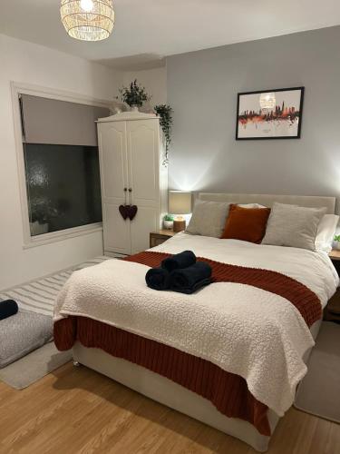 a bedroom with a large bed and a large window at London Zone 2, Private, Cosy accommodation near Canary Wharf in London