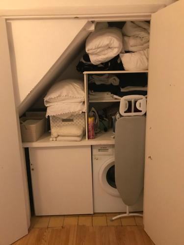 a closet with a washing machine and a washer at London Zone 2, Private, Cosy accommodation near Canary Wharf in London