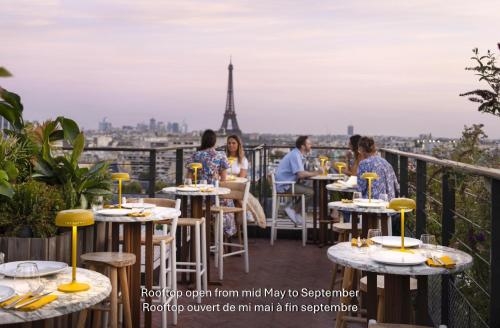 a restaurant with a view of the eiffel tower at Villa M in Paris