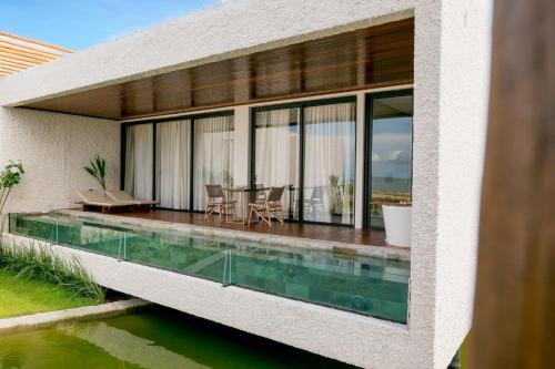 an external view of a house with a swimming pool at Nanii Hotel in São Miguel do Gostoso