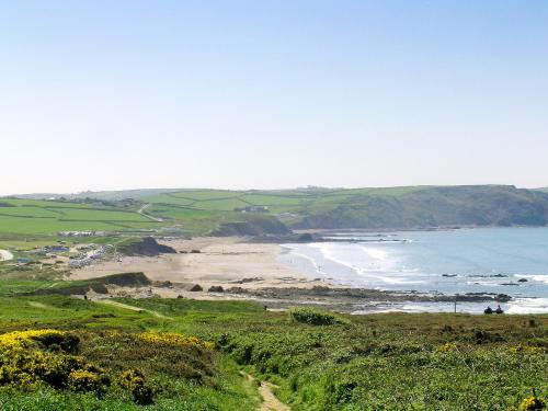 a view of a beach and the ocean from a hill at Foxglove Lodge - Uk13448 in Halwill
