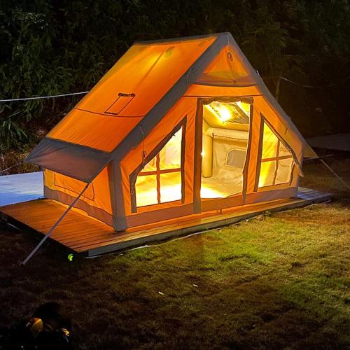 a small tent sitting on the grass at night at FulleRulle in Båtskärsnäs