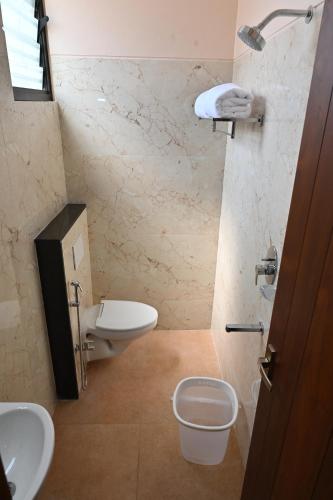 a bathroom with a sink and a toilet in a room at Majestic Grand in Madurai