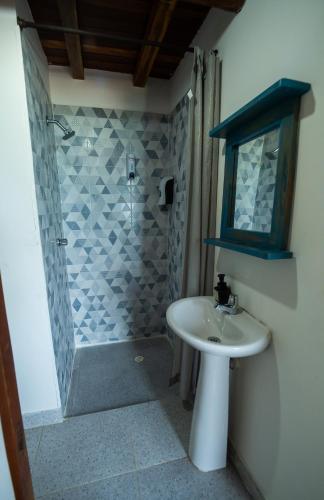 a bathroom with a sink and a shower at Cristal Blue Barú in Baru