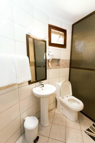 a bathroom with a toilet and a sink at Keys Hotel in Moshi