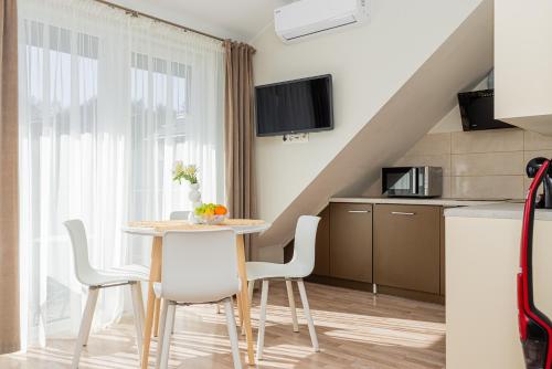 a kitchen and dining room with a table and chairs at Vila Dia Palanga in Palanga