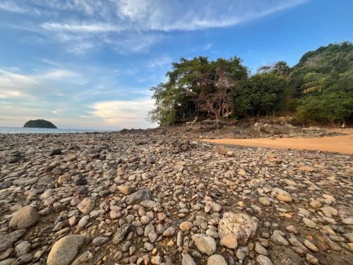 a large pile of rocks on a beach at Island Life Bungalows in Ko Khan