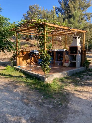 a small house with a wood structure with a stove at Bellas Glamping in Arrentela