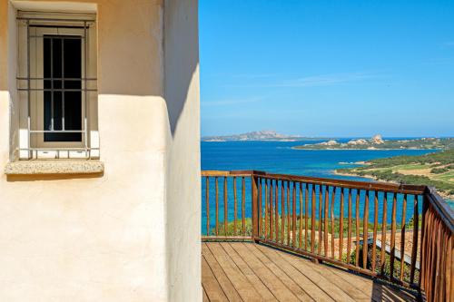 a balcony of a building with a view of the ocean at Villa Paradiso in Cala Bitta