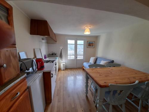 - une cuisine et un salon avec une table et un comptoir dans l'établissement Les Citronniers, à Belvianes-et-Cavirac