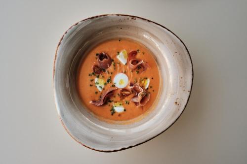 a bowl of soup with an egg in it at Prinsotel Alba & Spa in Cala d´Or